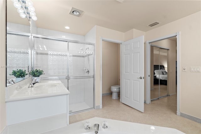 bathroom with toilet, tile patterned flooring, vanity, and walk in shower