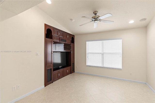 unfurnished living room with ceiling fan, light tile patterned flooring, and lofted ceiling