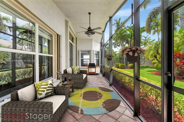 sunroom / solarium featuring ceiling fan and a healthy amount of sunlight