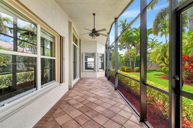 sunroom with ceiling fan and plenty of natural light