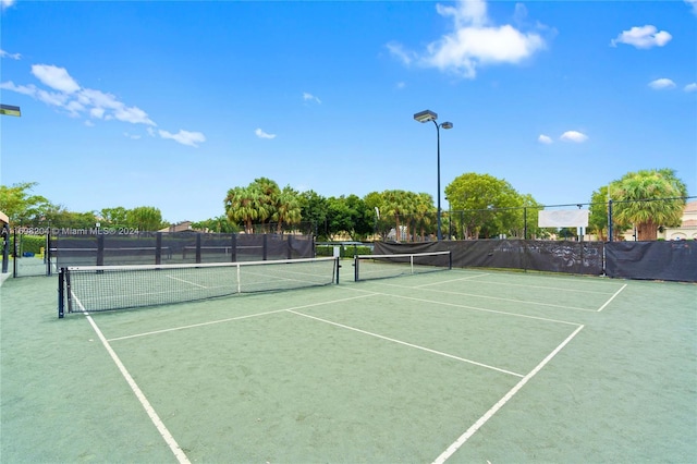 view of tennis court featuring basketball court