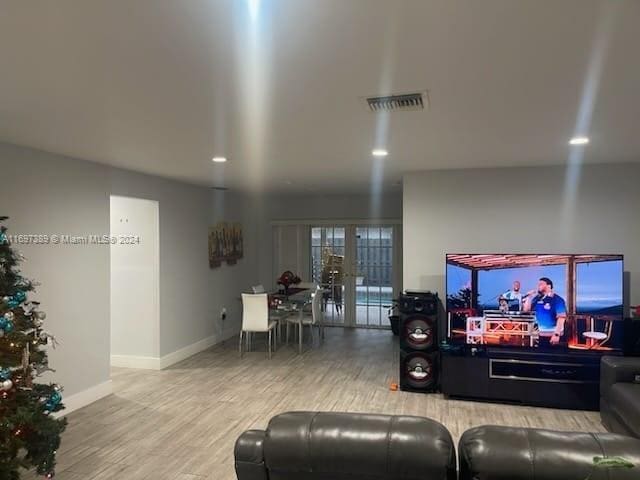 living room with hardwood / wood-style floors and french doors