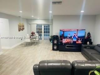 living room featuring wood-type flooring and french doors