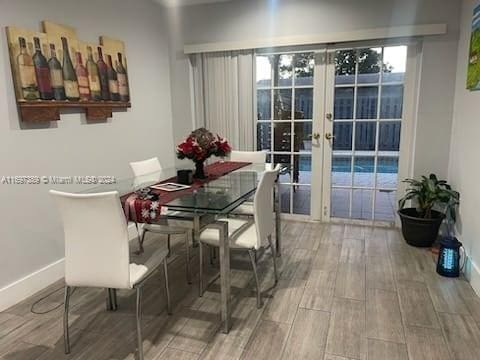 dining room with french doors and hardwood / wood-style flooring