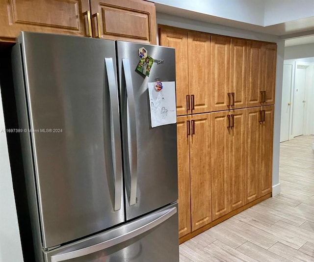 kitchen featuring light hardwood / wood-style floors and stainless steel refrigerator