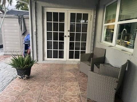 property entrance with french doors and a patio