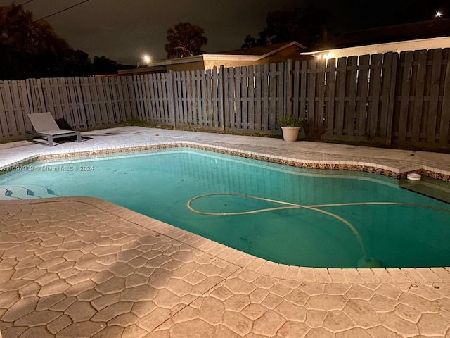 pool at night with a patio