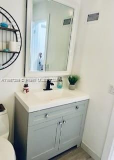 bathroom with vanity and toilet