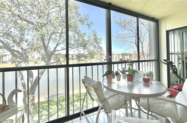 sunroom / solarium with a water view