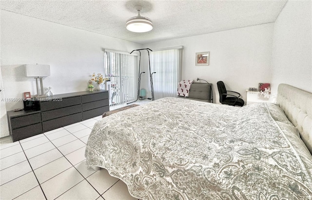 bedroom with access to exterior, a textured ceiling, and light tile patterned floors