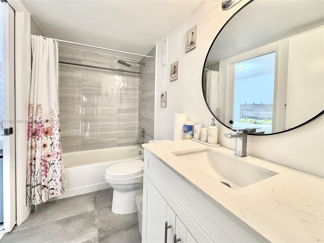 full bath featuring toilet, shower / tub combo with curtain, and vanity