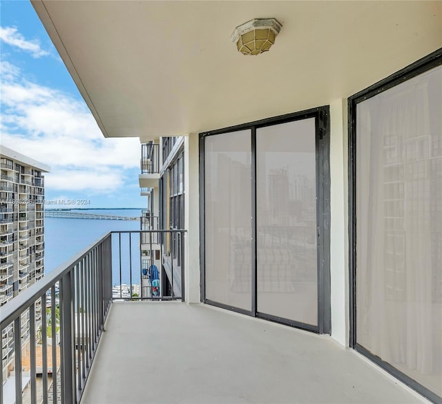 balcony featuring a water view