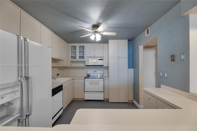 kitchen with white appliances, white cabinets, sink, ceiling fan, and light tile patterned flooring