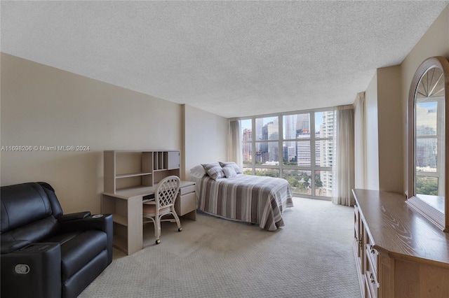 bedroom featuring a textured ceiling and light carpet