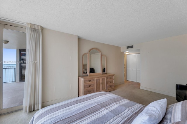 carpeted bedroom with a textured ceiling