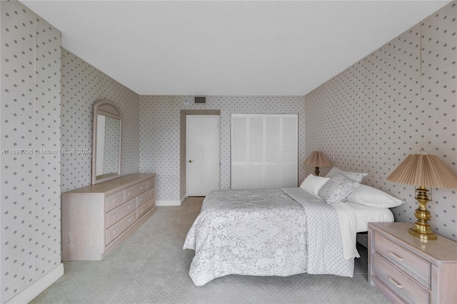 carpeted bedroom with a textured ceiling