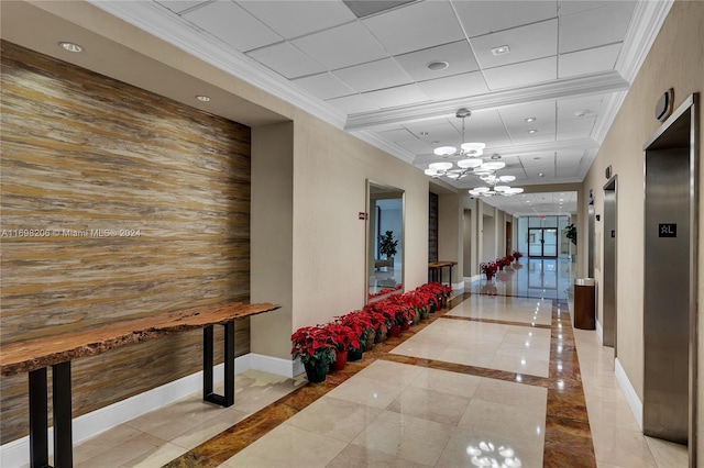 corridor with wood walls, crown molding, and a chandelier