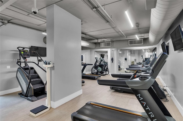 gym featuring light wood-type flooring