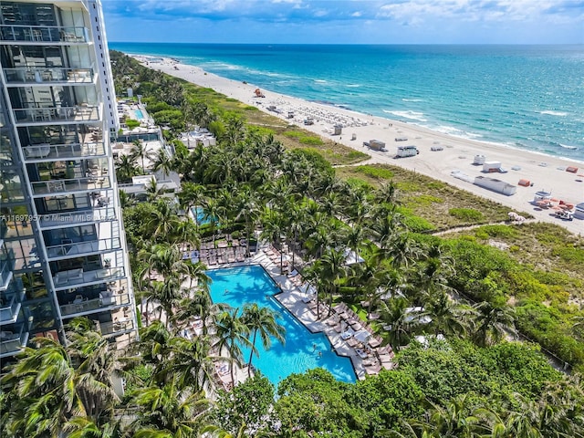 bird's eye view with a water view and a beach view