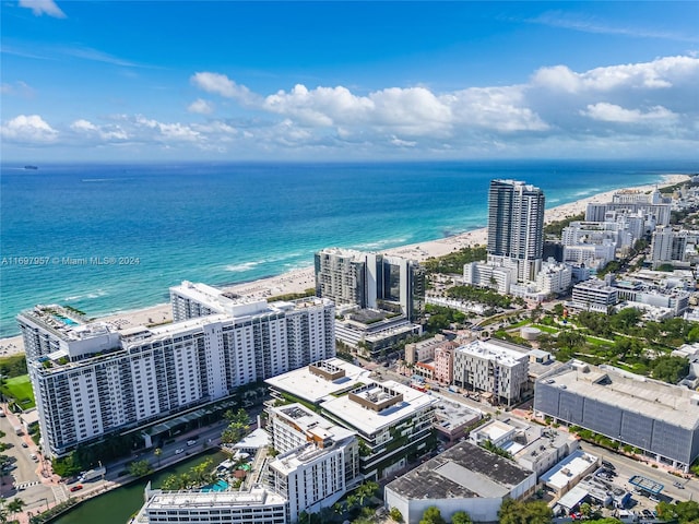 aerial view with a water view and a beach view