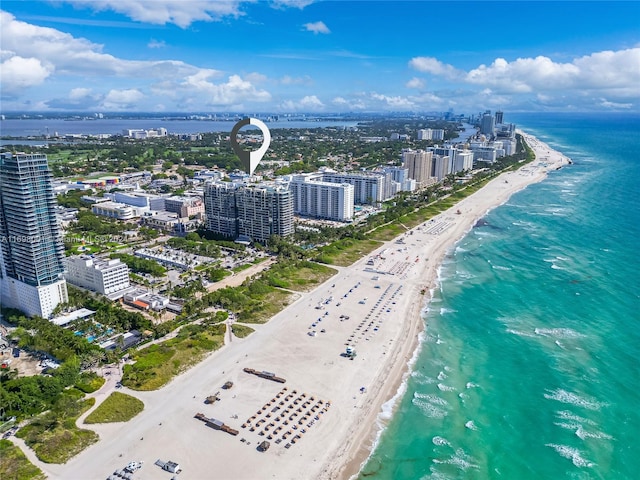 birds eye view of property featuring a beach view and a water view