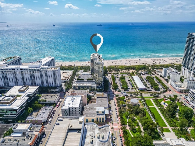 birds eye view of property featuring a beach view and a water view