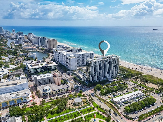 bird's eye view featuring a water view and a beach view