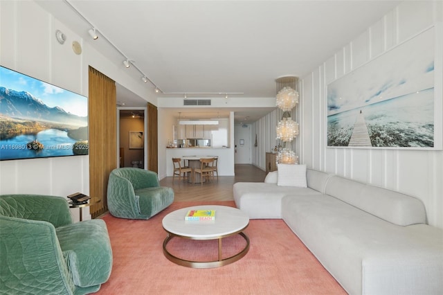2201 Collins Ave Unit 1015, Miami Beach, FL 33139 - living area featuring rail lighting, wood finished floors, and a decorative wall