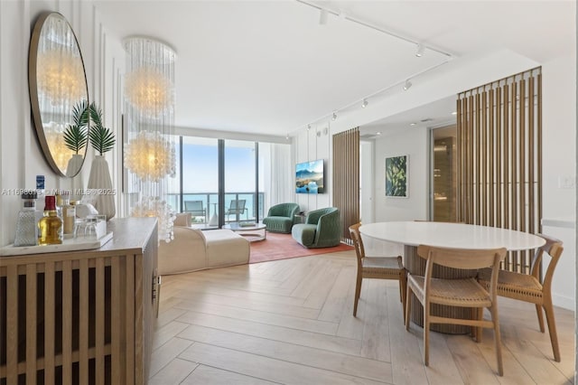 2201 Collins Ave Unit 1015, Miami Beach, FL 33139 - dining room featuring rail lighting and expansive windows