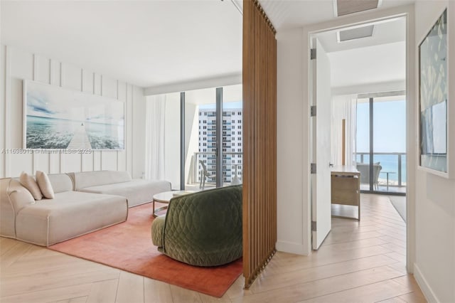 2201 Collins Ave Unit 1015, Miami Beach, FL 33139 - living room with attic access, wood finished floors, and baseboards