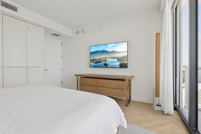 2201 Collins Ave Unit 1015, Miami Beach, FL 33139 - bedroom with light wood finished floors and baseboards