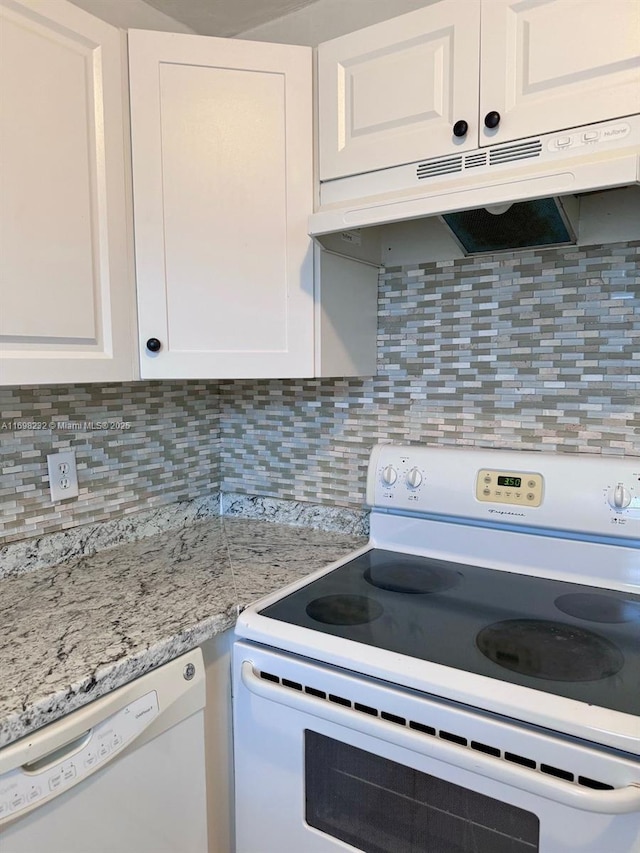 kitchen with white appliances, under cabinet range hood, and white cabinets