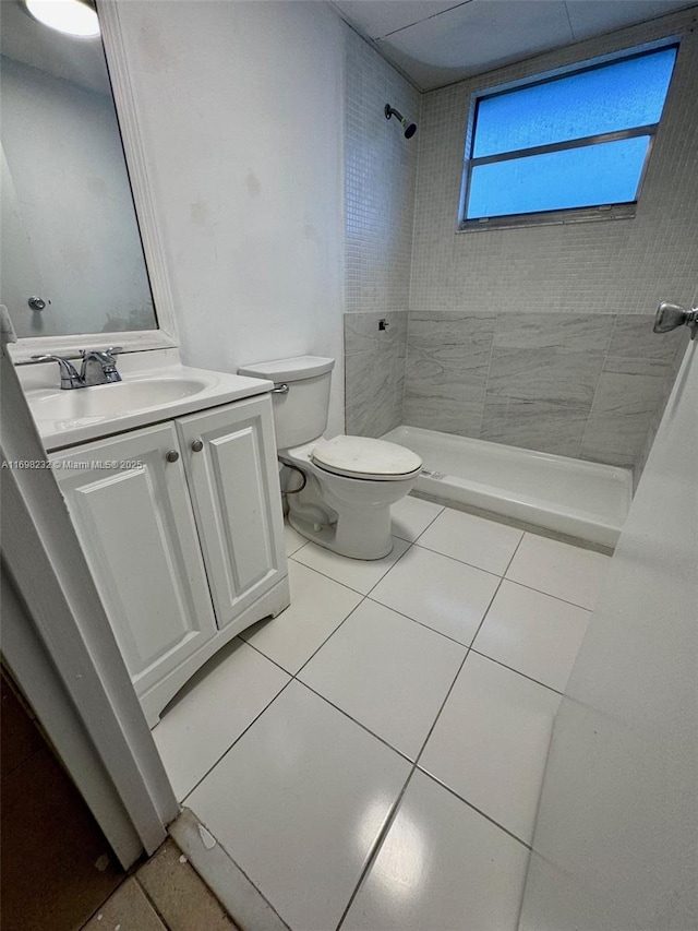 full bath featuring toilet, a stall shower, tile patterned floors, and vanity