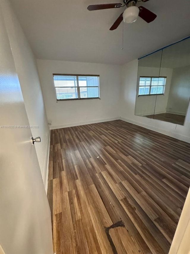 unfurnished bedroom featuring ceiling fan, wood finished floors, and baseboards