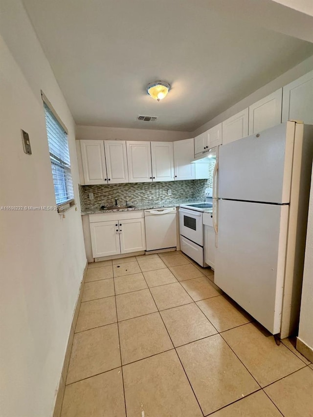 kitchen with tasteful backsplash, light countertops, white cabinetry, a sink, and white appliances