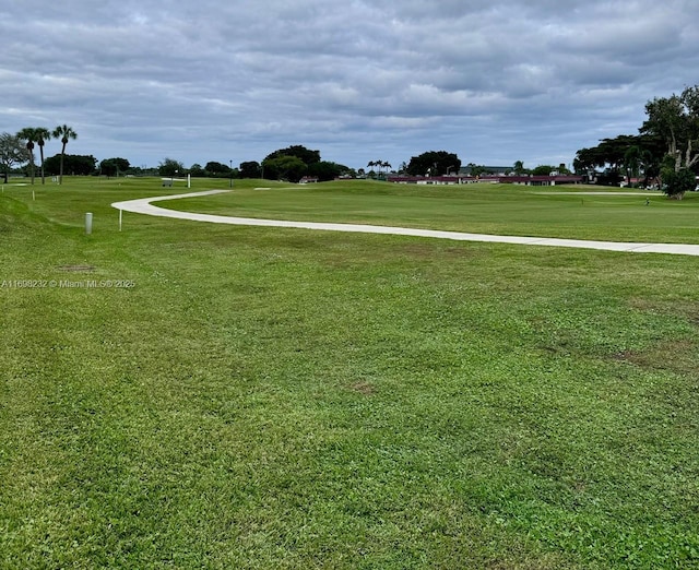 view of property's community with a yard