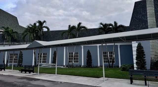 view of front of property with a front lawn and stucco siding