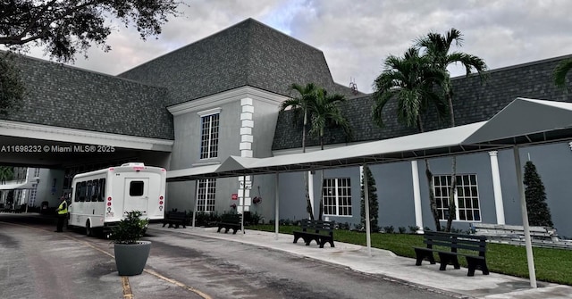 exterior space featuring roof with shingles