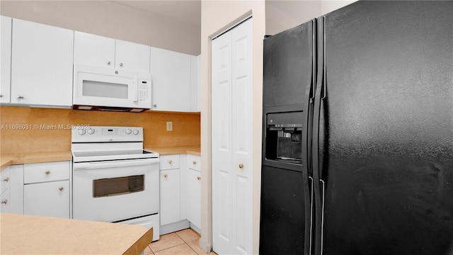 kitchen with white cabinets, light tile patterned floors, white appliances, and backsplash