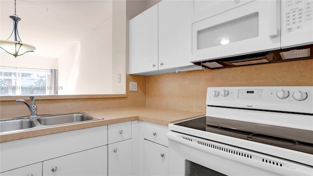 kitchen featuring sink, hanging light fixtures, tasteful backsplash, white appliances, and white cabinets