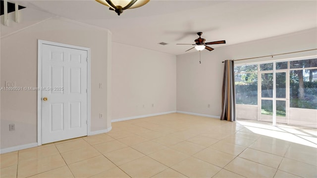 spare room with ceiling fan, light tile patterned flooring, and ornamental molding