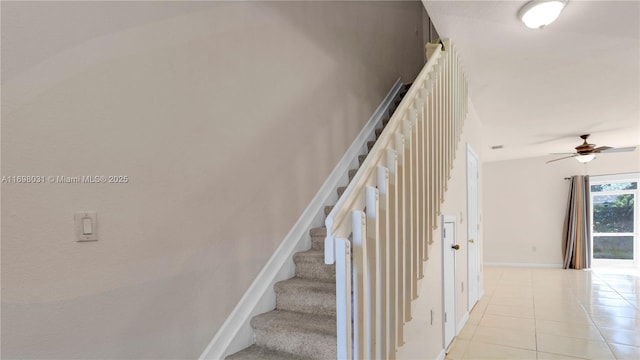 stairs with tile patterned floors and ceiling fan