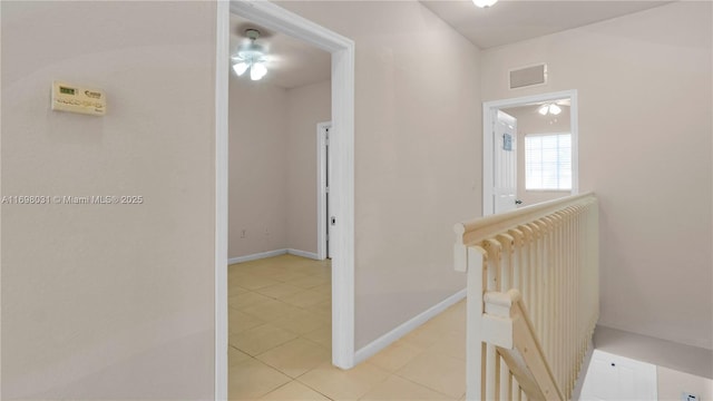 hallway featuring radiator and light tile patterned floors