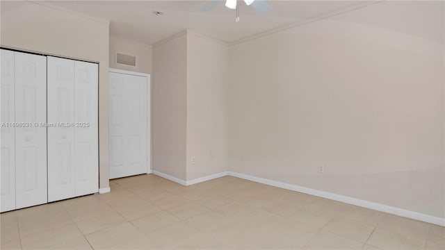 unfurnished bedroom with ceiling fan, ornamental molding, light tile patterned floors, and a closet