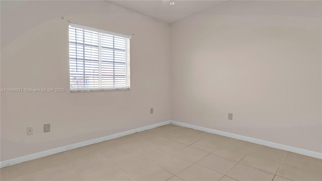 spare room featuring light tile patterned flooring