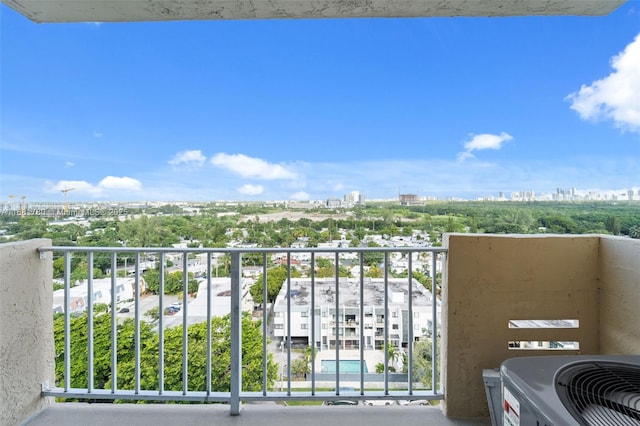 balcony with a view of city and central AC unit