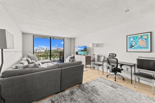 living room featuring floor to ceiling windows, a textured ceiling, and light tile patterned flooring