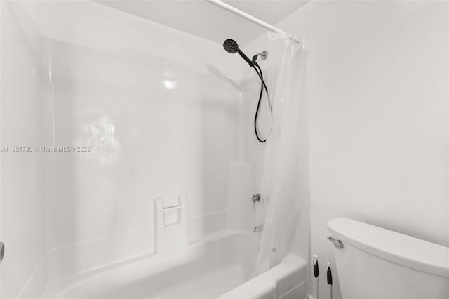 bathroom with shower / bathtub combination with curtain and toilet