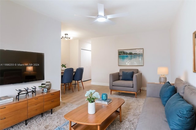 living room with light hardwood / wood-style floors and ceiling fan