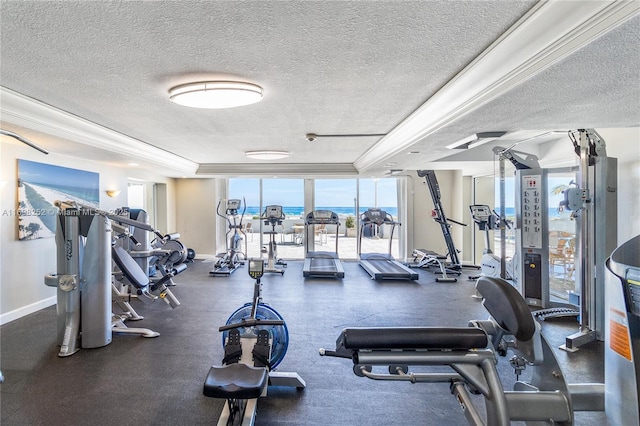 exercise room with a textured ceiling, a water view, and baseboards